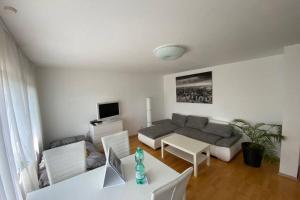 a living room with a couch and a table at Tübingen - auf dem Österberg - free parking in Tübingen
