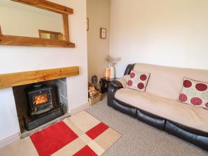 a living room with a couch and a fireplace at Ard na Gréine in Kilrean