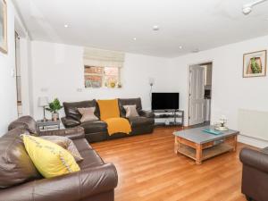 a living room with a couch and a coffee table at BB House in Bedford