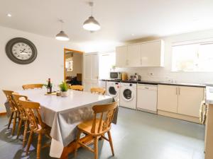 a kitchen and dining room with a table and chairs at BB House in Bedford