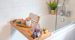 a wooden tray sitting on the edge of a bath tub at 3 The Gathering Chester Central in Chester +31 photos