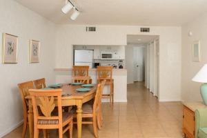 a dining room and kitchen with a table and chairs at Discovery Beach Resort in Cocoa Beach