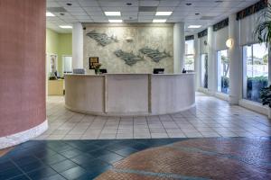 a lobby with a reception desk in a building at Discovery Beach Resort, a VRI resort in Cocoa Beach