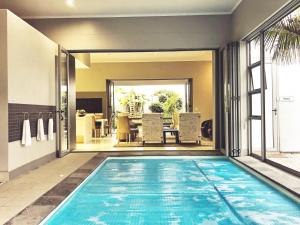 a swimming pool in the middle of a house at Be-Still Accommodation in Swakopmund