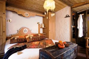 a bedroom with a large bed with a wooden headboard at le A by neige et roc in Morzine