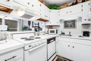 a kitchen with white cabinets and white appliances at Bee Branch 27 in Sugar Mountain