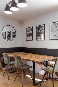a dining room with a wooden table and chairs at Interlude Megève 4 Stars 2BR Parking & Garden in Megève