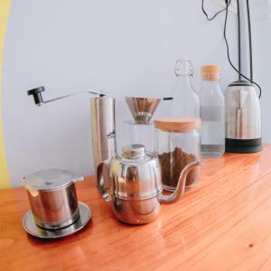 a wooden table with various kitchen items on it at AUR KUNING HOSTEL SYARIAH Bukittinggi in Bukittinggi