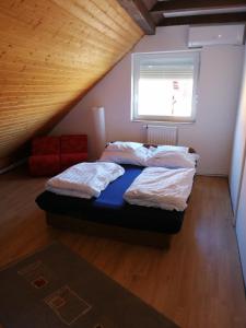 A bed or beds in a room at Szent György Vendégház