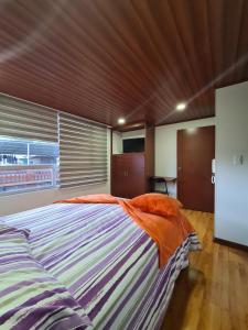 Posteľ alebo postele v izbe v ubytovaní Hotel Casa Huesped Kiwi