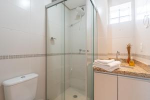 a bathroom with a shower and a toilet and a sink at Apartamento Rua Casemiro de Abreu, 199 in Porto Alegre +9 photos