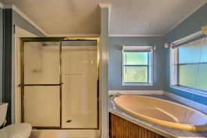 a bathroom with a tub and a toilet at Family-Friendly Home with Deck by Rainbow Springs! in Williston +22 photos