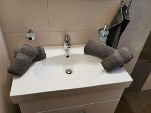 a white sink with a faucet in a bathroom at Ferienwohnung Magdalena in Stumm +42 photos
