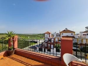 a balcony with a view of the ocean and buildings at Casa Camino del Agua in Castilleja de la Cuesta