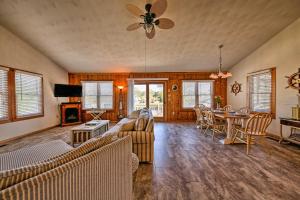 a living room with a couch and a table at OBX Getaway with Boat Dock on Colington Harbour in Kill Devil Hills