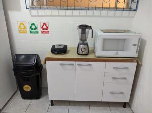 a kitchen with a microwave and a blender on a counter at Casa de Mainha Friendly Hostel in Salvador