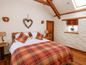 Ένα ή περισσότερα κρεβάτια σε δωμάτιο στο Blueberry Cottage