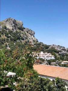 a mountain with houses on top of it at Apartamento El Jazmín in Grazalema