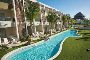 a large pool in front of a house at Dreams Onyx Resort & Spa - All Inclusive in Punta Cana