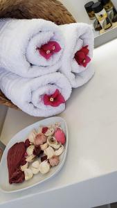 a plate of food on a table with towels at Alkyon Suites in Áyios Vasílios