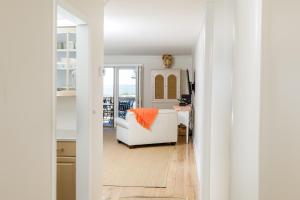 a living room with a white couch and a window at 1313 Pelican Watch - Seabrook Island - Beachfront 5 Star Condo - Fido Friendly in Seabrook Island +107 photos