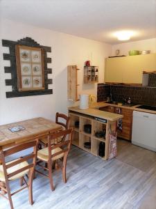 uma cozinha com uma mesa e uma mesa e cadeiras em le bel aval em Les Contamines-Montjoie