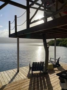 a bench sitting on a dock next to the water at Finca Vela Lodge in Bocas Town