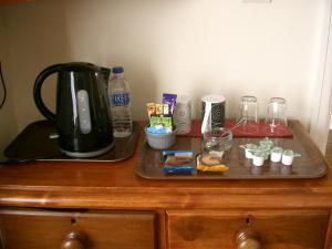 a wooden table with a tray with a coffee maker on it at Paths End in Port Isaac