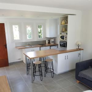 een keuken met een houten tafel en stoelen bij Les Lucioles in Cavalaire-sur-Mer