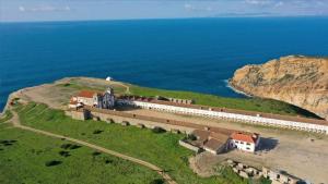 an aerial view of a castle on a hill next to the ocean at Alojamento Espigas in Azoia