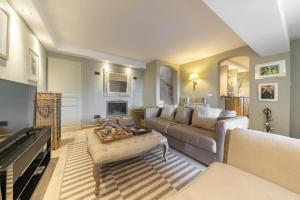 a living room with a couch and a fireplace at Villa La Lavande in Valbonne