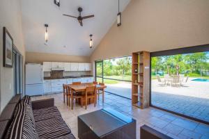 a large kitchen and dining room with a table at SWISS 105 - Lake Olsen in Clermont