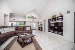 a large living room with a couch and a tv at SWISS 23 - Lake Stephanie in Clermont