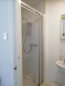 a shower with a glass door in a bathroom at Elderslie Guest House in Oban