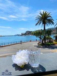 un vase en verre assis sur une table avec des fleurs dans l'établissement AL CASTELLO-VISTA MARE -ROMANTICO e CENTRALE a 20 METRI DAL MARE-toll parking at 15 euro per day to be booked in advance -subject to availability, à Rapallo