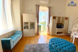 a living room with a blue couch and a large window at WELCOME RIVIERA - AL CASTELLO-VISTA MARE -ROMANTICO e CENTRALE a 20 METRI DAL MARE-toll parking at 15 euro per day to be booked in advance -subject to availability in Rapallo