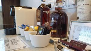 a counter with two bottles of alcohol and someemen at Apartment Holata 401 in Hradec Králové