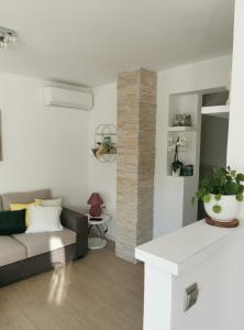 a living room with a couch and a table at Kenzo apartment in Senj