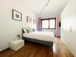 a bedroom with a large bed and a window at Vista Reale Apartment in Caserta