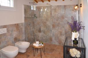 a bathroom with a shower and a toilet and a sink at B&B Le Col-vert in Lido di Dante +58 photos