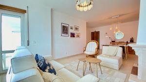 a living room with a white couch and a table at Amazing Baleal Beach Apartment - Kila I in Ferrel