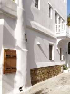 a white building with a wooden door at Narcissus Luxury Suites in Naxos Chora