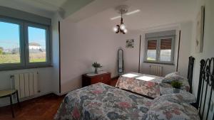 a living room with a table and a bed and a window at CASA LA REVERENDA in Barcia