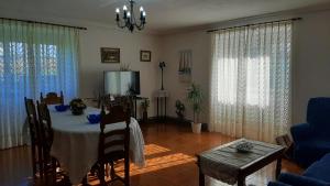 a living room with a table and a blue couch at CASA LA REVERENDA in Barcia