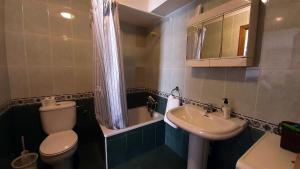 a small bathroom with a toilet and a sink at CASA LA REVERENDA in Barcia +22 photos