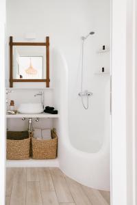 a white bathroom with a sink and a shower at SilvAir by Silvernoses, Mykonos in Dexamenes