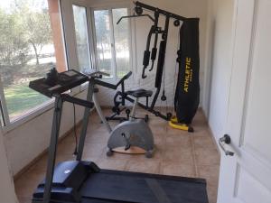 a room with a gym with a exercise bike and a treadmill at Hotel Posada Terrazas con pileta climatizada in Potrero de los Funes