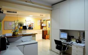 an office with a desk with a computer in it at Hotel Aurora in Milan
