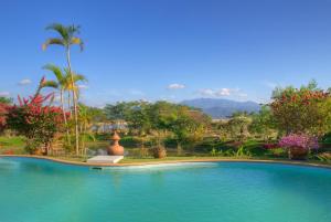 a swimming pool with a view of a resort at Maekok River Village Resort in Mae Ai