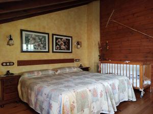 a bedroom with a bed and two pictures on the wall at Asturias Apartamentos Rurales Naveces in Naveces